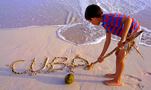 CUBA, Varadero, beach, boy writing 'Cuba' on sand, CUB229JPL 300